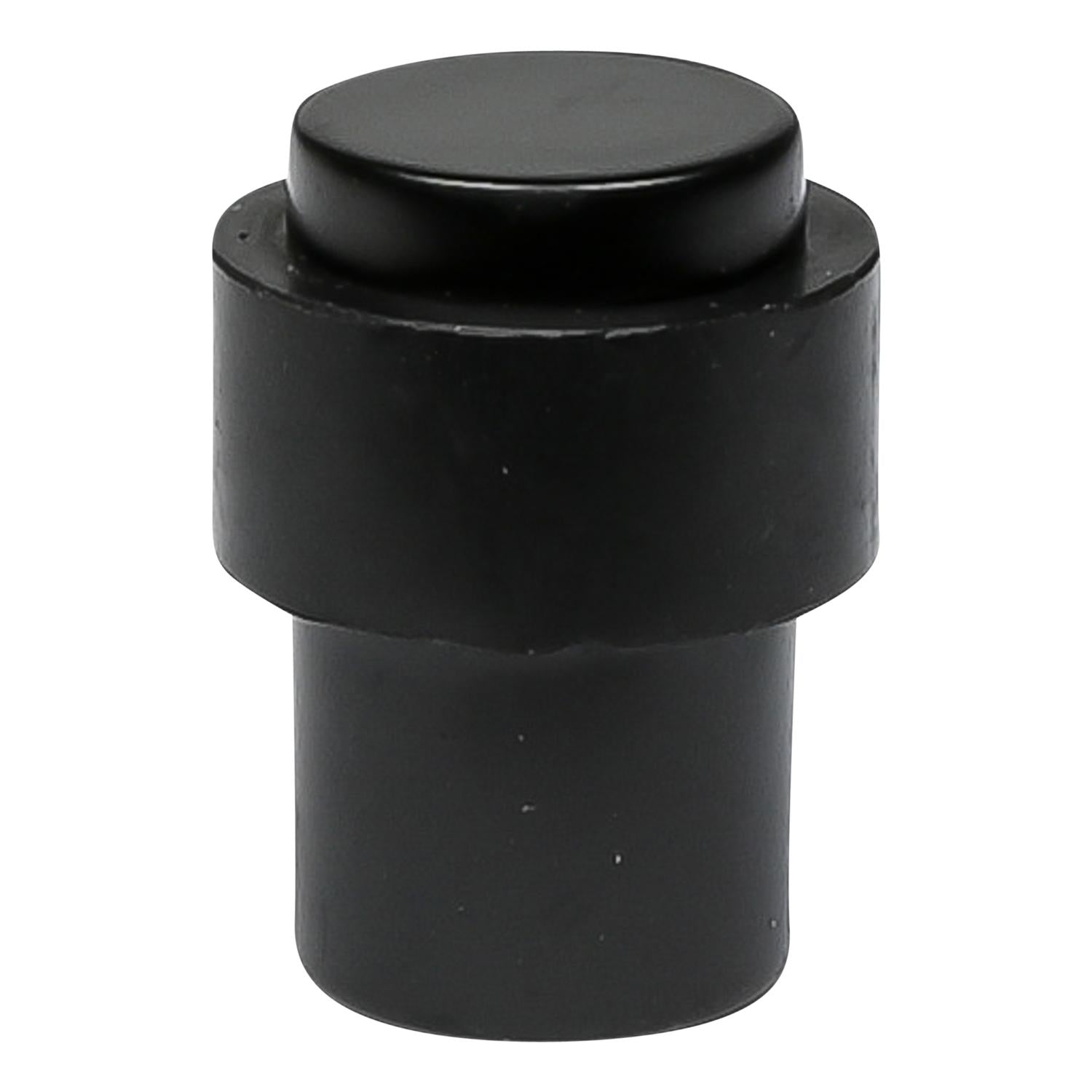 Schwarzer Türstopper in zylindrischer Form mit flacher Oberseite, freistehend auf weißem Hintergrund gezeigt.