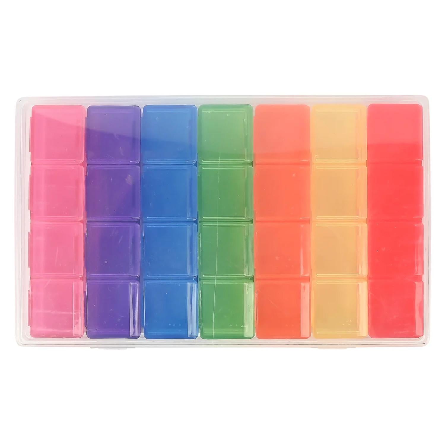 Geschlossene, transparente Wochen-Pillenbox mit rechteckiger Form, gefüllt mit farbigen Tagesfächern in Pink, Lila, Blau, Grün, Orange, Gelb und Rot, gleichmäßig in Reihen angeordnet vor weißem Hintergrund.