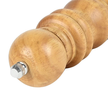 Schräge Seitenansicht einer Holz-Gewürzmühle mit abgerundetem Kopf und silberfarbenem Metallknopf, Maserung und gedrechselte Form deutlich sichtbar.